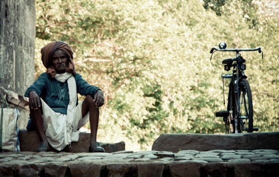 An old man sat at the Delhi Gate, tired with the chores of the day .. 
